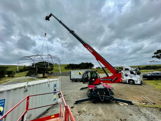 Telehandler lifting large steel framework structure